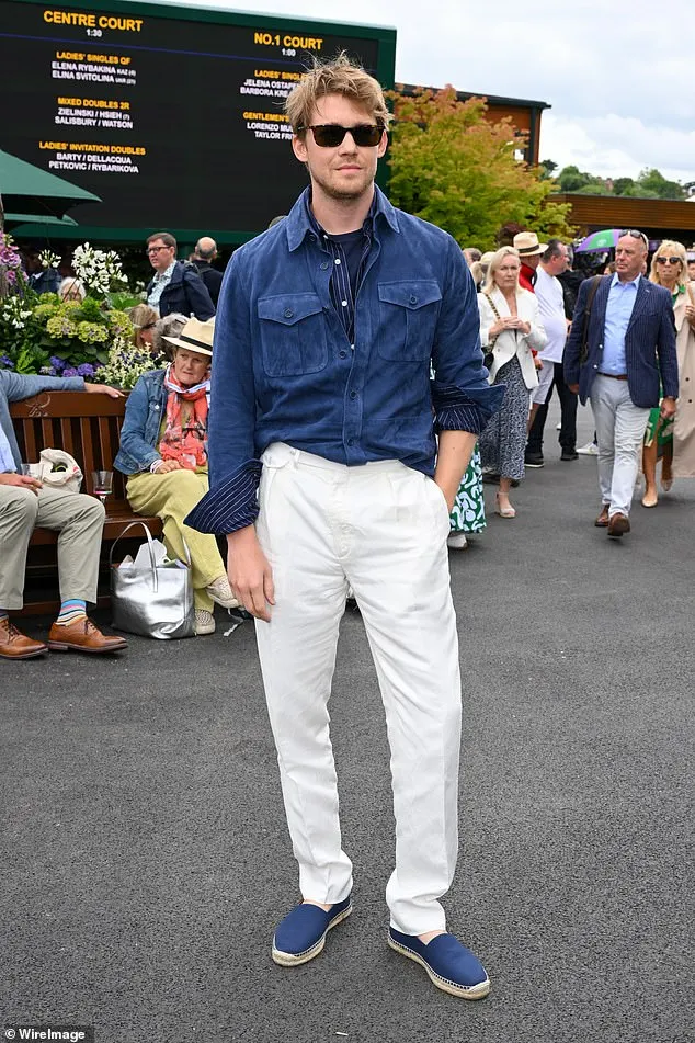 Joe Alwyn looked smart in a blue Ralph Lauren shirt and white chinos