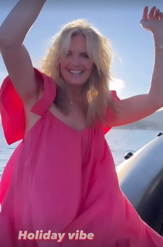 On a holiday, Penny Lancaster wore a flowing red dress.