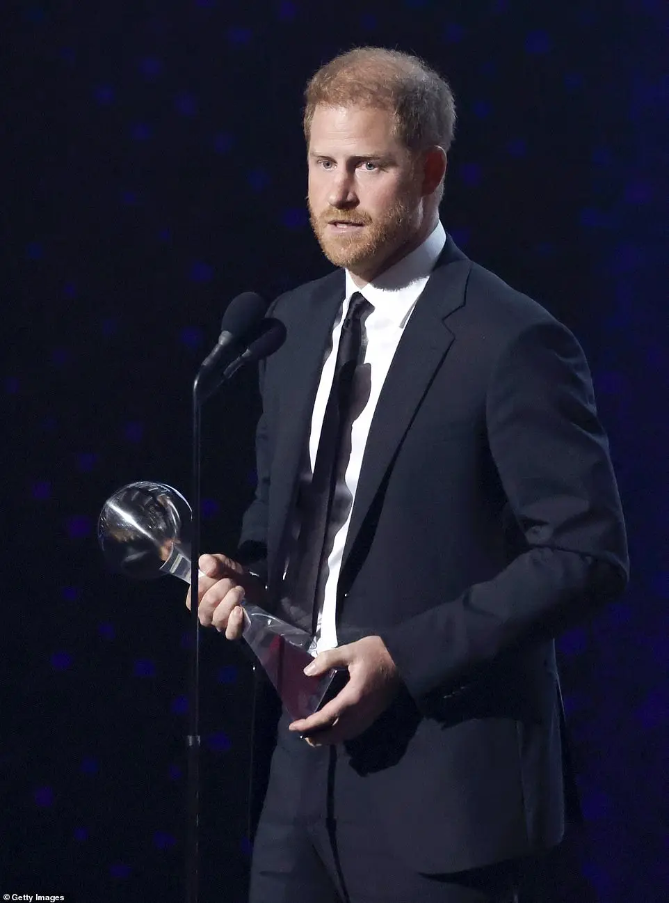 He sported an elegant black suit as he picked up the award, despite receiving backlash, with many Americans calling on him to turn it down