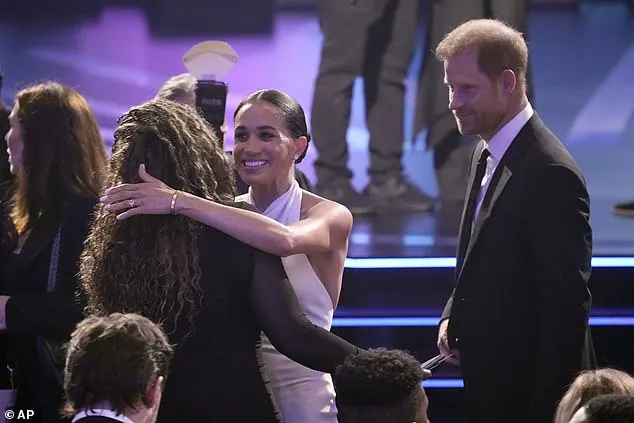 Before the start of the ceremony, Harry and Meghan were seen catching up with friends in the audience, with the Duchess leaning in to give one attendee a big hug