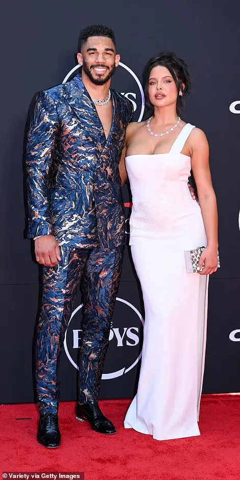 Evander Kane also favored blue, but his silver-flecked suit split the difference between camouflage and oil spill; seen with mara Teigen