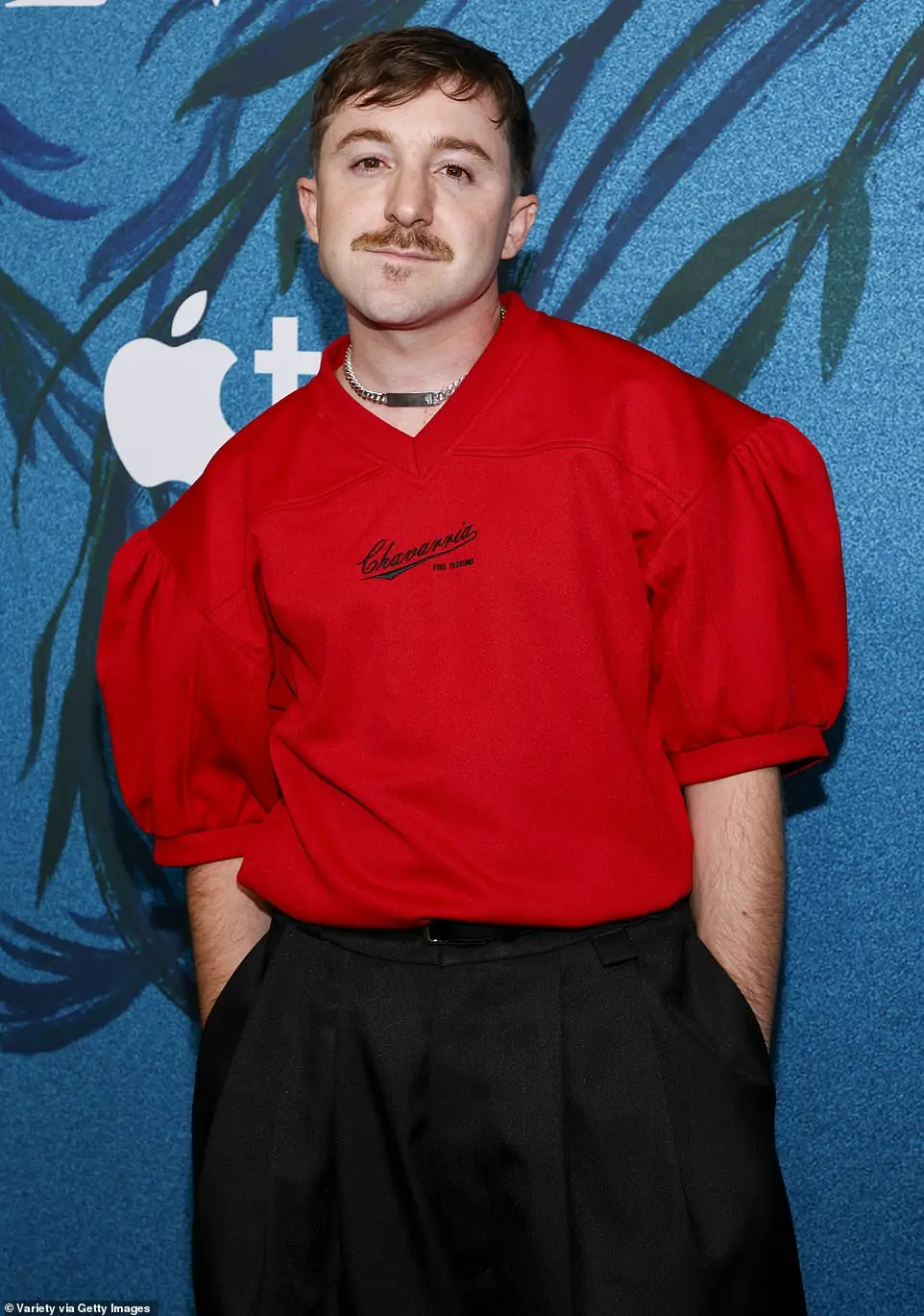 He added shiny black dress shoes and walked the red carpet with his brown hair cropped above his ears as he also rocked a mustache