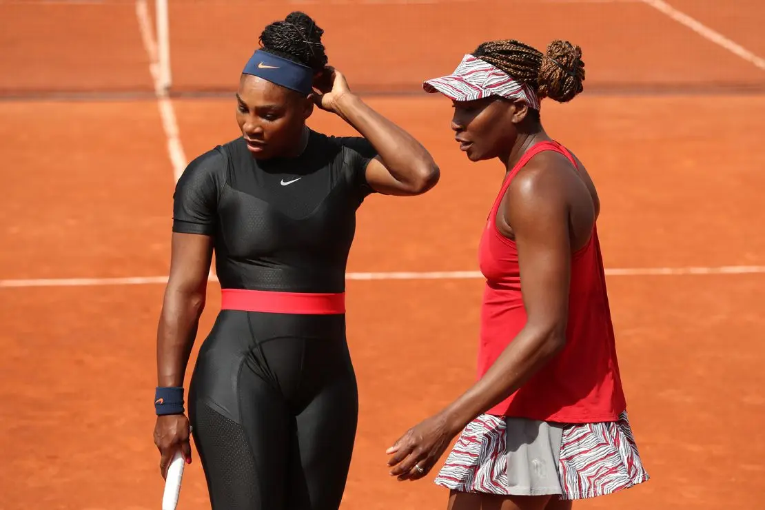 Serena and Venus Williams on the court at the 2018 French Open. The tournament said it wouldn't permit catsuits in future editions, but the Women’s Tennis Association amended their rules to allow leggings without skirts.