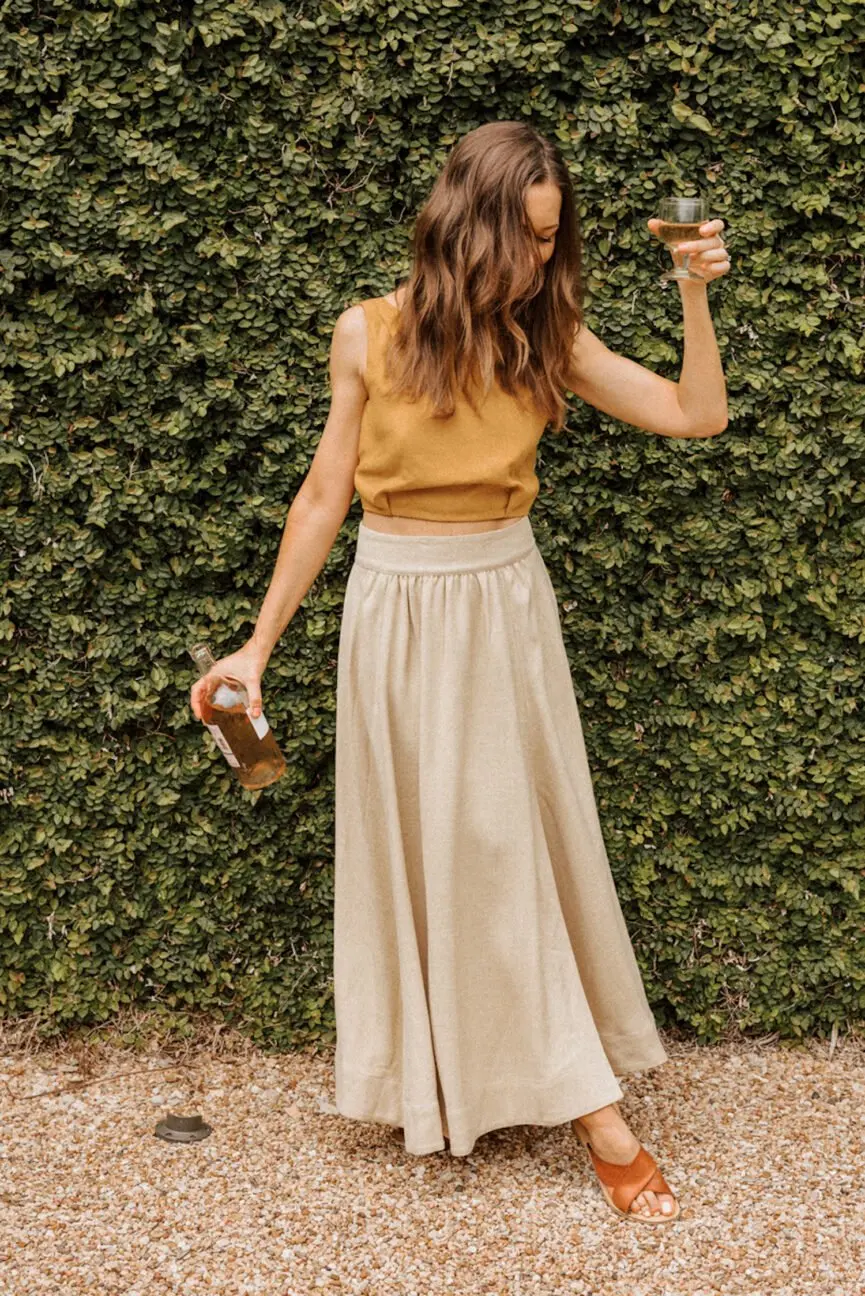 Woman wearing long linen skirt.