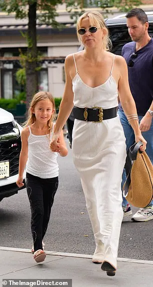 She rocked a chic white maxi dress accentuated by a wide black belt