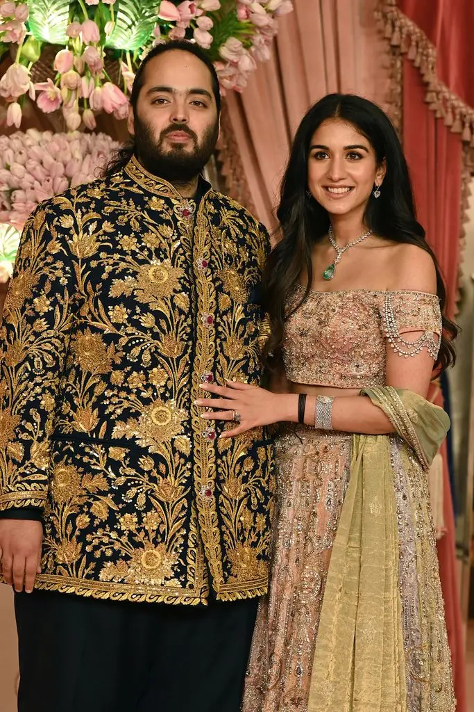 Anant Ambani son of billionaire tycoon and Chairman of Reliance Industries Mukesh Ambani and Radhika Merchant pose for a picture in gold outfits