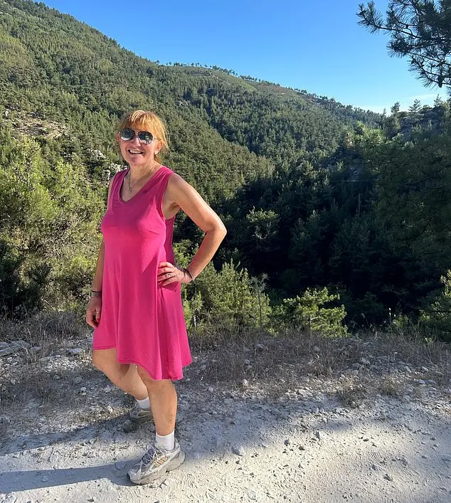 Angela poses in a pink dress while on holiday in the Greek countryside