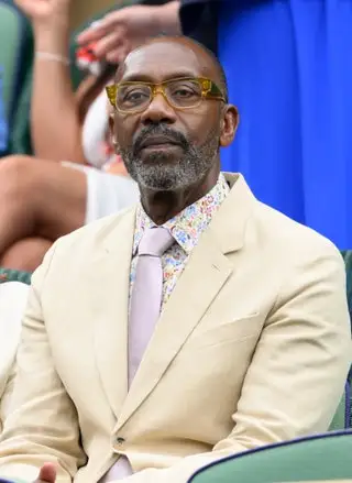 Image may contain Lenny Henry Blazer Clothing Coat Jacket Accessories Glasses Formal Wear Tie Face and Head