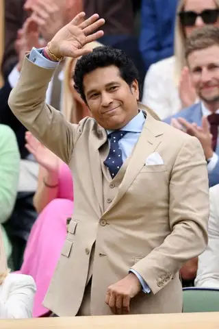 Image may contain Sachin Tendulkar Joe Root Accessories Formal Wear Tie Head Person Face Blazer Clothing and Coat