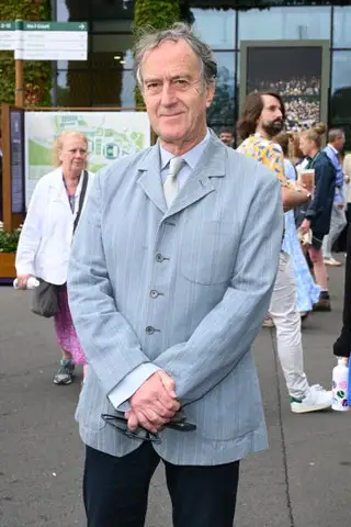 Image may contain Angus Deayton Blazer Clothing Coat Jacket Footwear Shoe Accessories Formal Wear Tie and Bag