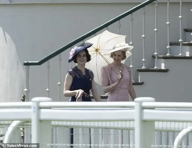 Michelle, 42, (left) cut a chic figure in a navy lace dress which she wore with a matching hat, while Laura, 37, looked elegant in a pale pink ensemble