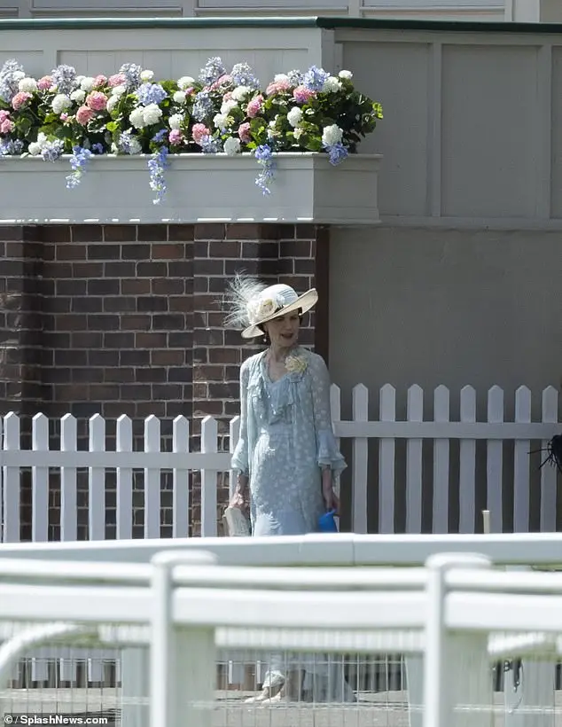 Elizabeth looked stunning in her pale blue dress and matching hat as she strolled around on set