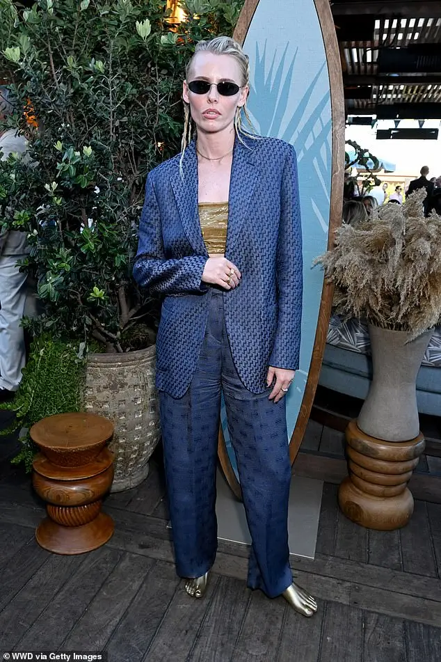 Model Lauren Wasser showed off her cool style in a patterned suit and unique feet-shaped gold shoes