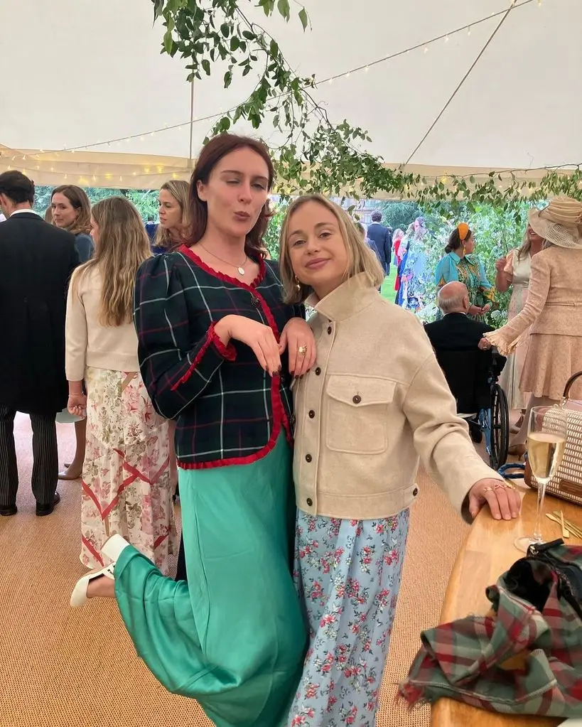 Lady Amelia Windsor in a blue floral dress with a friend