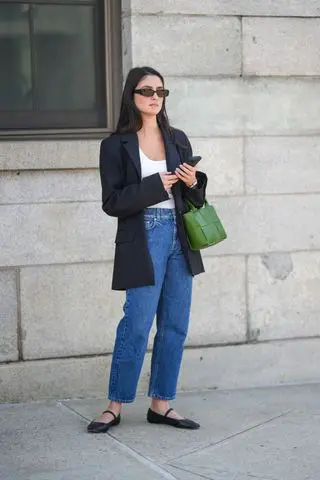 woman wearing blazer, white tank, jeans, and flats