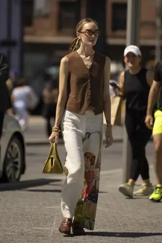 woman wearing tailored vest, pants, and loafers