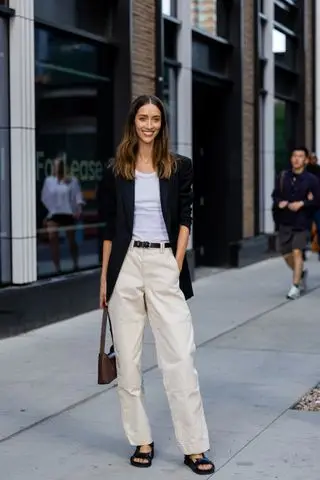 woman wearing blazer, white tank, trousers, and sandals