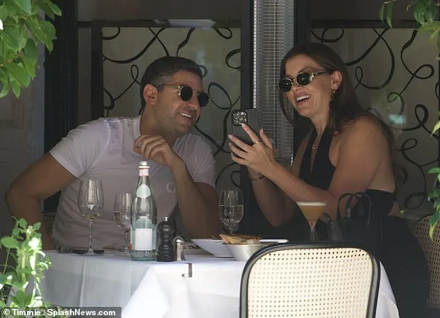 The new couple were seen laughing and chatting over lunch as they showed each other their phones and basked in the heat during their intimate meal on the restaurant's veranda