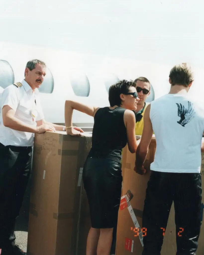 beckhams and aiport staff loading box onto plane