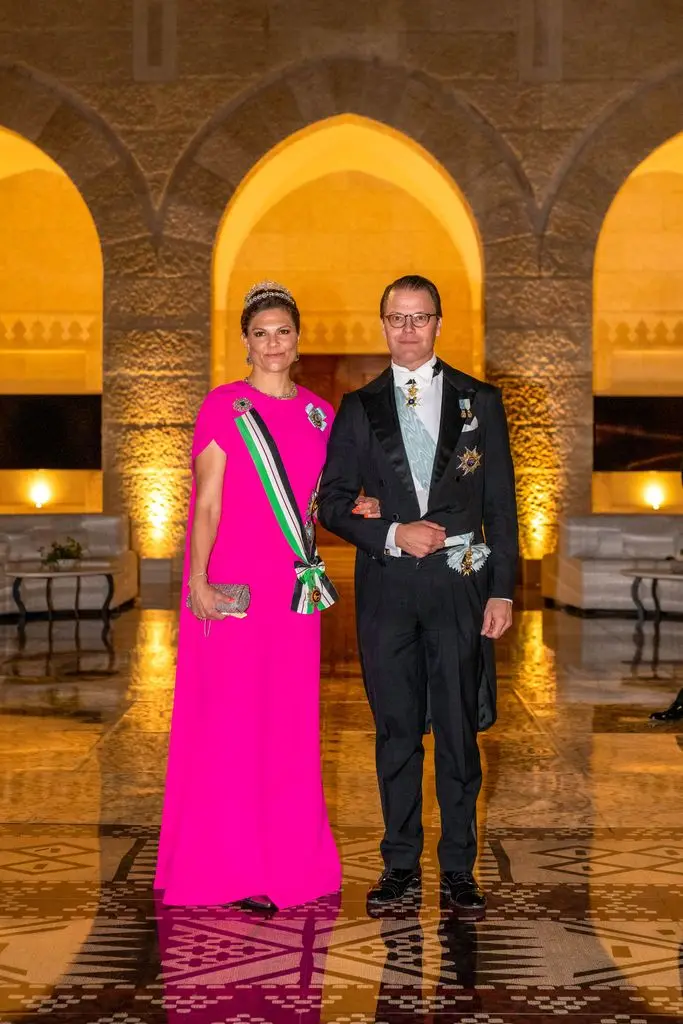 Crown Princess Victoria in a pink caped dress with her husband