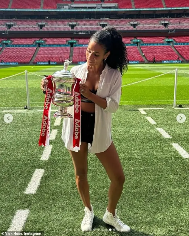 And Vick flashed her toned midriff in a tiny bralette and black shorts for another photo of her proudly holding the Women¿s FA Cup