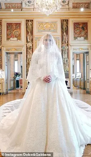 Kitty made her grand entrance in a Victorian-inspired ivory lace gown, incorporating a high neck, bustier-style bodice and puffed shoulders