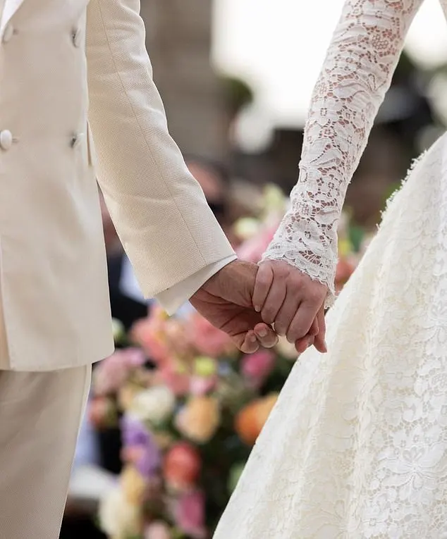 The bride and groom held hands at the altar