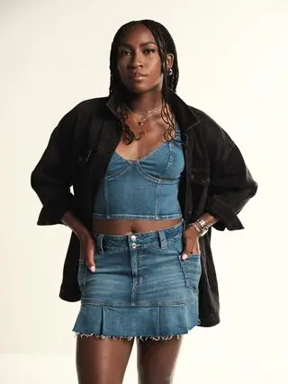 Coco Gauff poses in a new American Eagle campaign wearing a denim tank top and matching skirt.