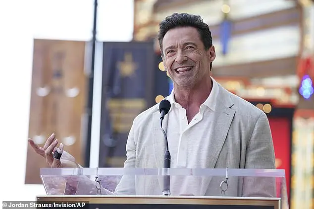 Jackman looked typically hunky as he took to the stage - showing off a bandaged finger