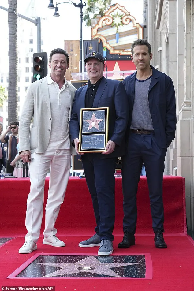 Feige was delighted as he posed with Jackman and Reynolds