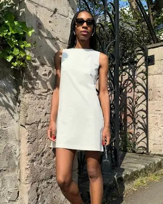 Influencer wears a shift dress.