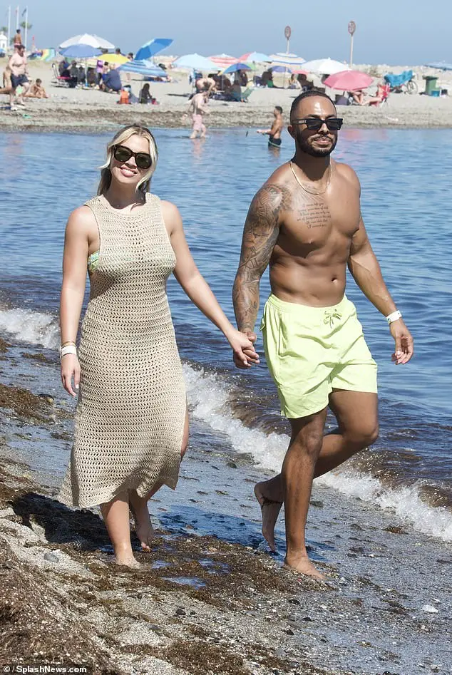 Molly Rainford and Tyler West looked every inch the loved-up couple as they were snapped packing on the PDA during a romantic beach stroll in Marbella, Spain