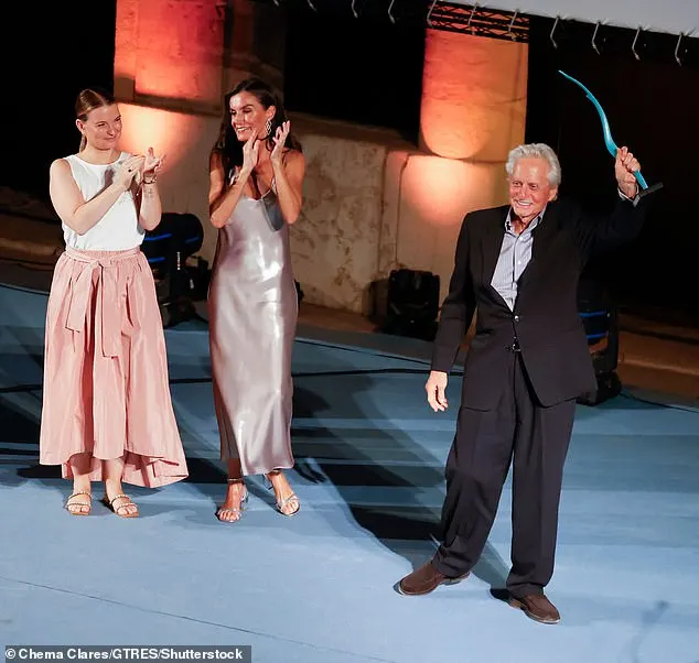 Michael proudly brandished his award, which was presented to him by Queen Letizia, at the festival