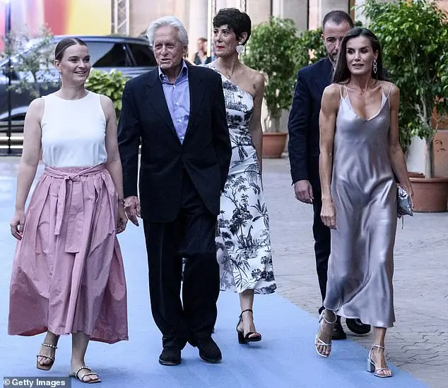 Michael too looked dapper in an elegant black suit and pinstripe shirt as he walked alongside Letizia