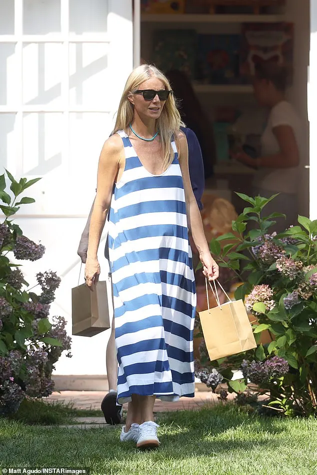 The actress, 51, displayed her effortless style in a flowing blue and white striped maxi dress, with a low scoop neckline giving a glimpse of her cleavage