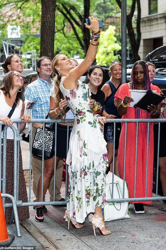 Lively (born Brown) leaned way back as she took a selfie with waiting fans