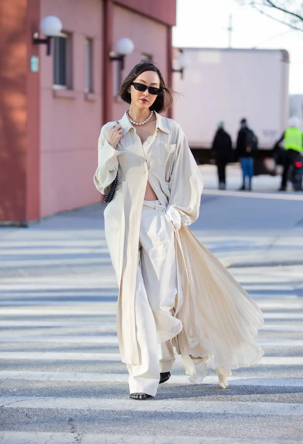 new york, new york february 15 chriselle lim seen wearing button up dress in creme white, pants, cropped top, necklace, sunglasses, black bag outside peter do during new york fashion week on february 15, 2022 in new york city photo by christian vieriggetty images