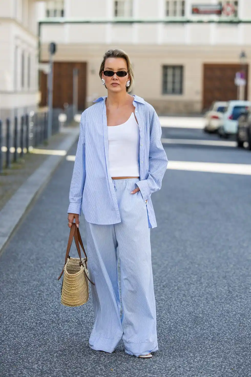 berlin, germany may 01 tina haase is seen wearing arket blue striped button shirt and pyjama pants, y project white ribbed tanktop, beige loewe basket bag, celine sunglasses on may 01, 2024 in berlin, germany photo by christian vieriggetty images