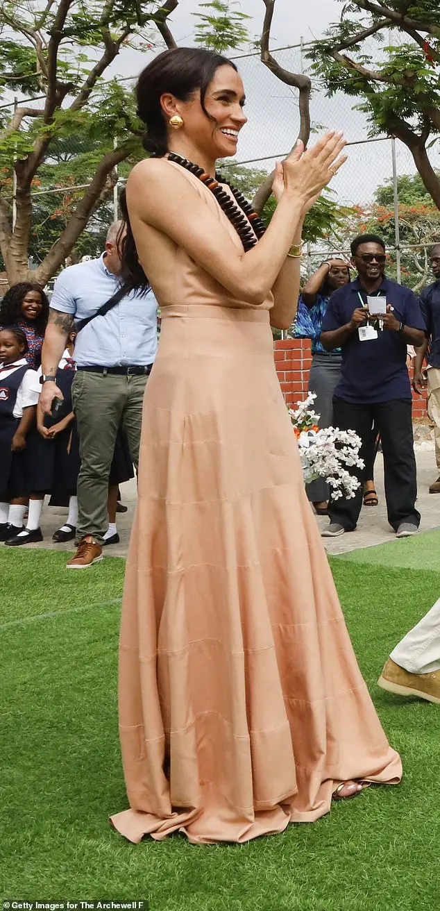 Meghan Markle wears a long ruffled dress as she visits Lightway Academy in Abuja, Nigeria, in May 2024