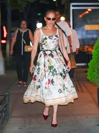 Jennifer Lopez walks in New York City wearing a floral dress and burgundy Gucci pumps