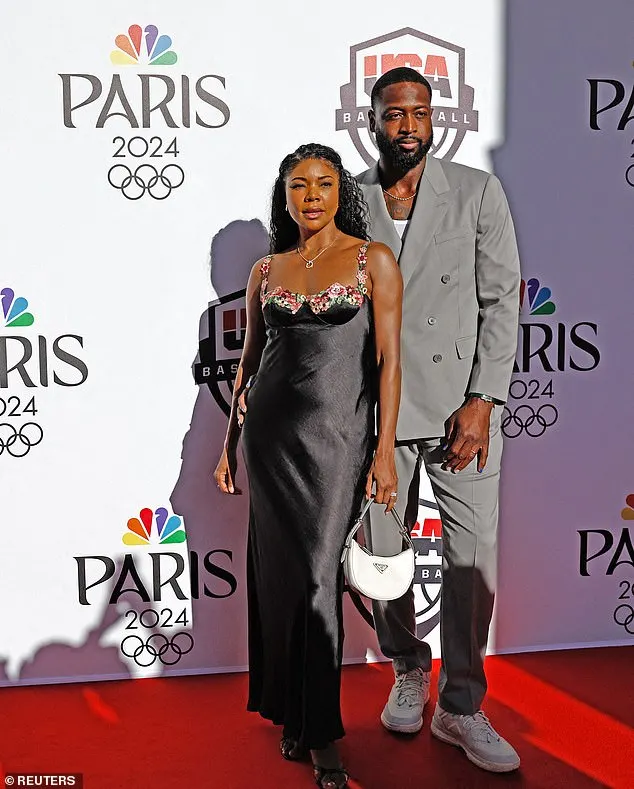 The Bring It On star stunned in a black silk dress with a floral trim, which she accessorized with a white Prada Arqué bag, retailing for $2,750