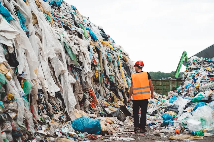 Rubbish dump filled with discarded clothing and rubbish.