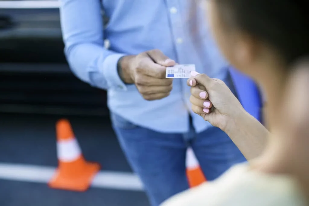 Woman receiving her drivers license