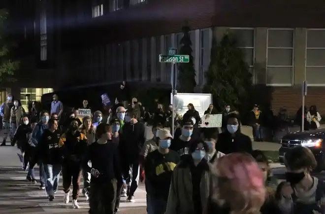 A large group of protesters circle the intersection of Jefferson and Madison streets on Oct. 16, 2023. Seven transgender protesters were charged with disorderly conduct and interference with official acts for their actions during protests against Cole's appearance and rhetoric.