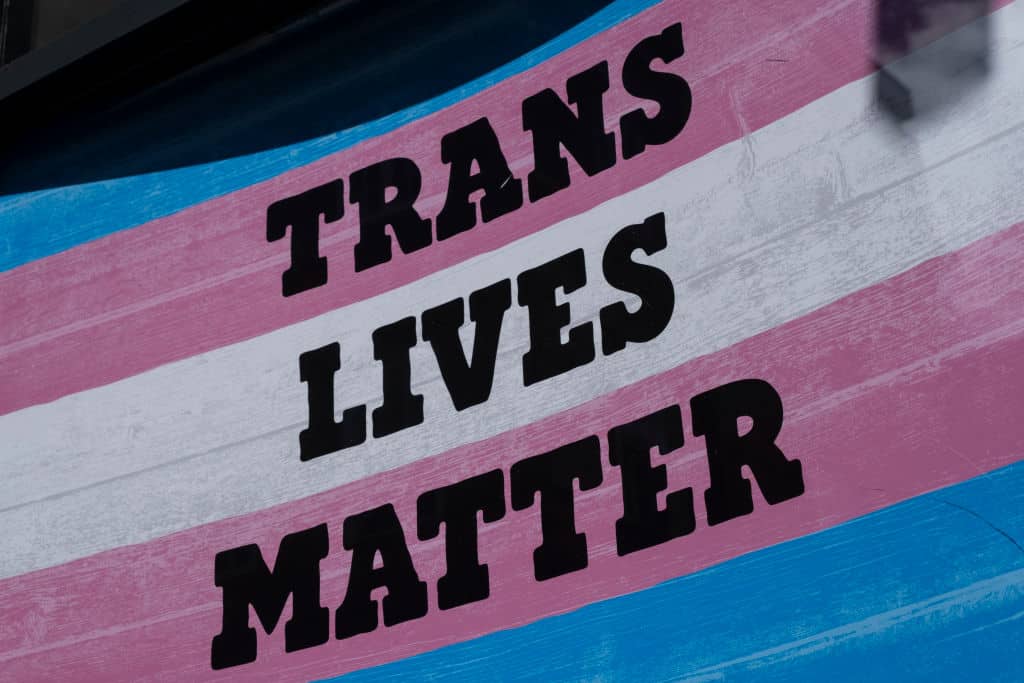 A trans flag with the words trans lives matter