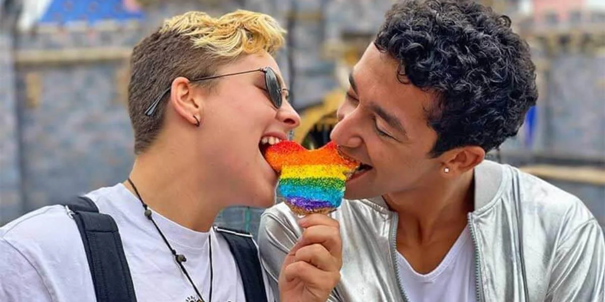 a couple shares a rainbow mickey rice crispy treat