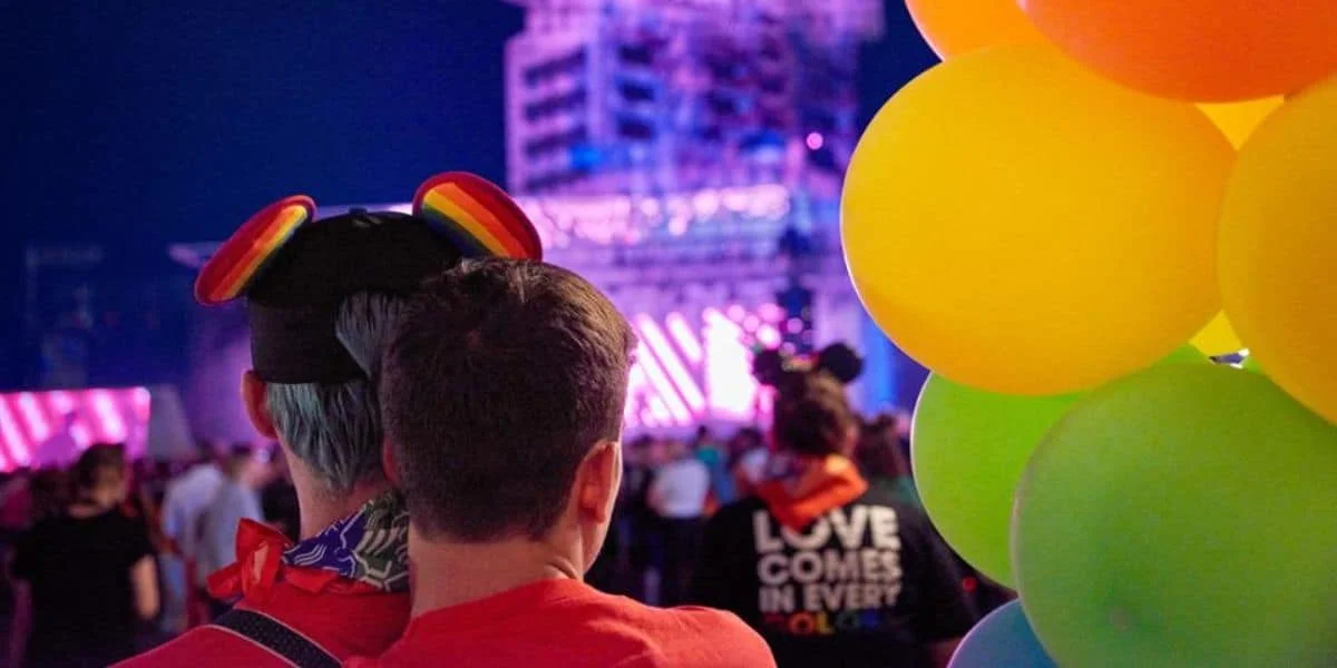 A couple hugs in front of the Tower of Terror at Disneyland Paris' Pride event