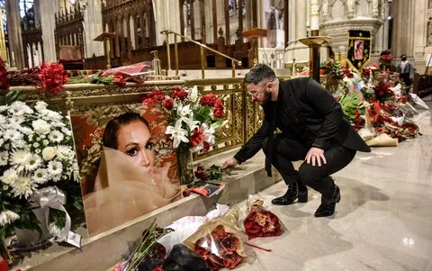 Mourner places flowers at the funeral of Cecilia Gentili, which was later denounced by the Roman Catholic Archdiocese of New York