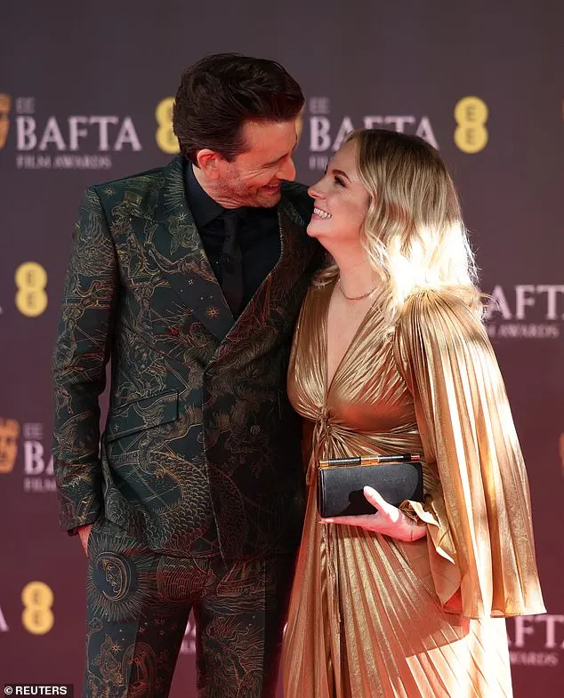 The actress, 39, was ever the supportive wife as she arrived on the red carpet with the actor, 52, in a glamorous gold pleated gown