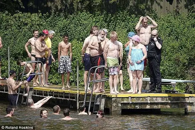 The group of women protesters, which called themselves Man Friday, faced a barrage of abuse and threats from hardline transgender activists (pictured: women in and beside the pool)